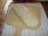 Versuch mit Backen auf dem Brotbackstein. Backschieber mit Gries bestreuen und Teig darauf plazieren, anschliessend mit Wasser einspr�hen